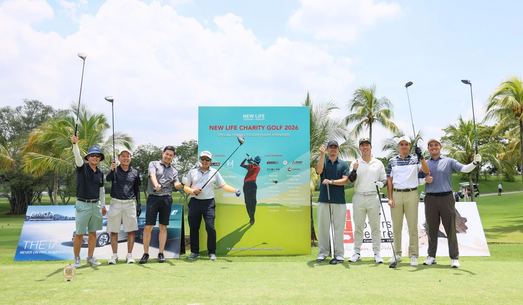Golfers at the New Life Charity Golf 2026 banner