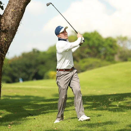A golfer teeing off
